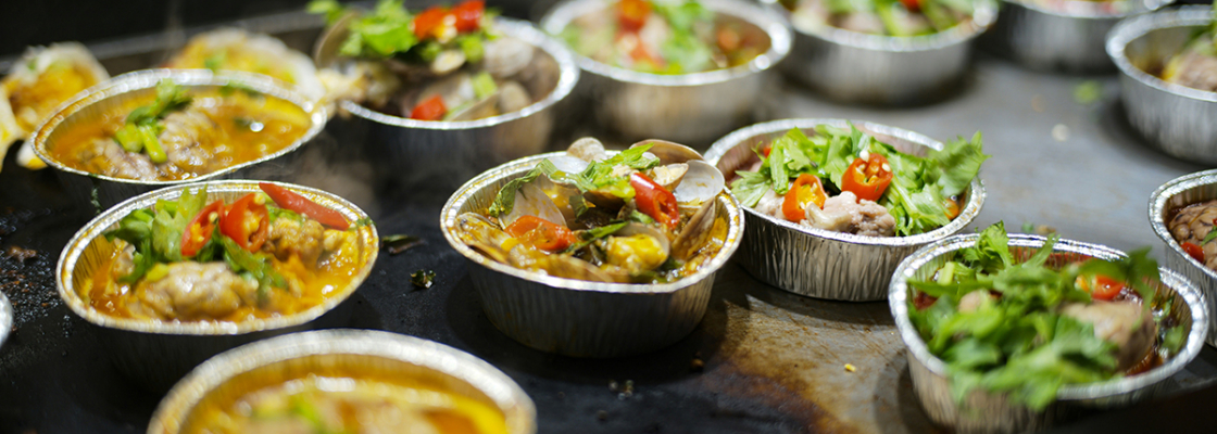 Small plates of food on a grill in a restaurant